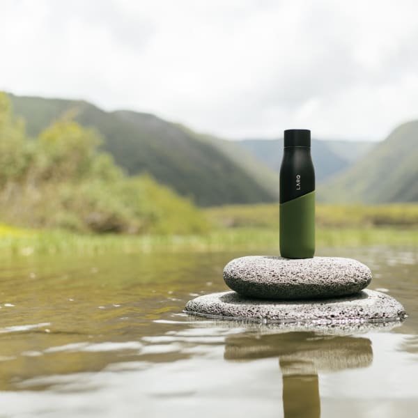 Photo of Larq Bottle PureVis™ - Black / Pine on a rock in water