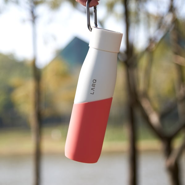 Photo of Active Loop with LARQ Bottle PureVis™ White/Coral hanging on a finger